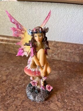 Pink and Yellow Fairy Figurine on Mushroom